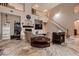 Cozy living room showcases a fireplace, neutral color scheme, staircase, and access to multiple rooms for easy flow at 5416 Irish Spring St, Las Vegas, NV 89149