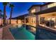 Stunning backyard with a refreshing pool, spa, covered patio, and lush landscaping, perfect for relaxation at 5416 Irish Spring St, Las Vegas, NV 89149