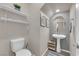 Cozy powder room features stylish decor, a pedestal sink, and convenient shelving at 56 Lomita Heights Dr, Las Vegas, NV 89138