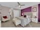Plush bedroom features purple accent wall, furry stools and bright lamps for an inviting ambiance at 56 Lomita Heights Dr, Las Vegas, NV 89138