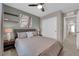 Neutral-toned bedroom with ceiling fan, closet, and a decorative painting enhances its appeal at 56 Lomita Heights Dr, Las Vegas, NV 89138