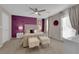 Striking bedroom with purple accent wall, stylish furniture, and bright natural light at 56 Lomita Heights Dr, Las Vegas, NV 89138