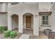 Close-up of townhome entry with arched porch, neat landscaping, and tiled entrance at 56 Lomita Heights Dr, Las Vegas, NV 89138