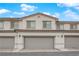 Charming townhome featuring neutral stucco, roof tile details, and an attached two-car garage at 56 Lomita Heights Dr, Las Vegas, NV 89138
