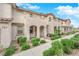 Inviting townhome featuring stucco exterior, arched entry, and well-maintained landscaping at 56 Lomita Heights Dr, Las Vegas, NV 89138