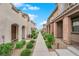 Neat townhome exteriors with walkway and manicured landscaping between buildings at 56 Lomita Heights Dr, Las Vegas, NV 89138