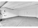 Spacious garage with painted walls, sealed concrete floor, and modern lighting at 56 Lomita Heights Dr, Las Vegas, NV 89138