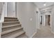 Hallway with carpeted stairs, white walls and open doorways at 56 Lomita Heights Dr, Las Vegas, NV 89138