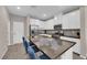 Modern kitchen with white cabinets, stainless appliances, and a large island with bar seating at 56 Lomita Heights Dr, Las Vegas, NV 89138