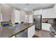 Open kitchen features a large island, stainless steel appliances, and sleek white cabinetry at 56 Lomita Heights Dr, Las Vegas, NV 89138