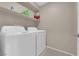 Functional laundry area with modern white appliances and ample shelving space at 56 Lomita Heights Dr, Las Vegas, NV 89138