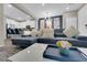 Spacious living room boasts plush seating and opens to a modern kitchen and dining area at 56 Lomita Heights Dr, Las Vegas, NV 89138