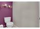 Purple accent wall in toilet room with decorative shelf at 56 Lomita Heights Dr, Las Vegas, NV 89138