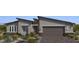 Charming single-story home featuring a two-car garage, stone accents, and desert landscaping in a modern style at 6312 Zephyr Peak Ct, Las Vegas, NV 89149