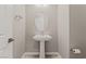 Bathroom with pedestal sink and oval mirror at 6312 Zephyr Peak Ct, Las Vegas, NV 89149
