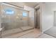 Bathroom with glass shower, tile walls, and wood-look tile flooring at 6312 Zephyr Peak Ct, Las Vegas, NV 89149