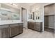 Bathroom with dual sinks, white countertops, and wooden cabinets at 6312 Zephyr Peak Ct, Las Vegas, NV 89149