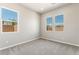 Empty bedroom with carpet, gray walls, and bright windows at 6312 Zephyr Peak Ct, Las Vegas, NV 89149