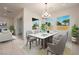 Elegant dining room with a marble table, modern chandelier, and large windows at 6312 Zephyr Peak Ct, Las Vegas, NV 89149