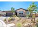 Attractive single-story home with a brick driveway, rock landscaping, and a two-car garage at 6312 Zephyr Peak Ct, Las Vegas, NV 89149
