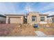Charming single-story home featuring a brick driveway, stone accents, and a two-car garage at 6312 Zephyr Peak Ct, Las Vegas, NV 89149