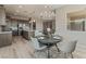 Open concept kitchen and dining area with stainless appliances and a center island at 6312 Zephyr Peak Ct, Las Vegas, NV 89149