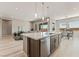 Modern kitchen with a center island, stainless steel appliances, and an open layout to the living and dining areas at 6312 Zephyr Peak Ct, Las Vegas, NV 89149