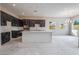 Kitchen featuring dark cabinetry, a large island, modern countertops, and stainless steel appliances at 6312 Zephyr Peak Ct, Las Vegas, NV 89149