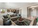 Inviting living room features a large sofa and is open to the modern kitchen and dining area at 6312 Zephyr Peak Ct, Las Vegas, NV 89149