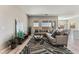 Stylish living room with modern decor, large windows, and open to the kitchen and dining room at 6312 Zephyr Peak Ct, Las Vegas, NV 89149