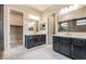 Elegant main bathroom with double vanities, modern fixtures, and a separate walk-in closet at 6312 Zephyr Peak Ct, Las Vegas, NV 89149