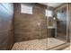 Modern shower with tile walls, pebble flooring, glass door, and contemporary fixtures at 6312 Zephyr Peak Ct, Las Vegas, NV 89149
