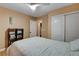 Cozy bedroom with a full bed, a ceiling fan with light, and white sliding closet doors at 6587 Lucky Boy Dr, Las Vegas, NV 89110
