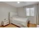Inviting bedroom with a white bed, hardwood floors, a window, and neutral walls at 6587 Lucky Boy Dr, Las Vegas, NV 89110