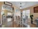 Well-lit dining area featuring a stylish chandelier, a dining table with upholstered chairs, and an open concept design at 6587 Lucky Boy Dr, Las Vegas, NV 89110