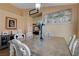 A dining area is set with a large wooden table, seating, and decorative wall art and cabinets at 6587 Lucky Boy Dr, Las Vegas, NV 89110