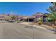 Residential street view of charming single-story home with stone accents, tile roof, desert landscaping and covered parking at 6587 Lucky Boy Dr, Las Vegas, NV 89110