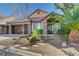 Beautiful single-story home featuring stone accents, a tile roof, and a landscaped front yard with mature trees and desert plants at 6587 Lucky Boy Dr, Las Vegas, NV 89110