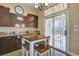 Eat-in kitchen features granite countertops, dark wood cabinetry, and backyard access at 6587 Lucky Boy Dr, Las Vegas, NV 89110