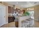 Modern kitchen with updated appliances, dark cabinets, and a breakfast bar offering views of the backyard at 6587 Lucky Boy Dr, Las Vegas, NV 89110