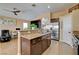 Inviting kitchen featuring granite countertops, a breakfast bar, and a smooth transition to the living area at 6587 Lucky Boy Dr, Las Vegas, NV 89110
