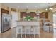 Updated kitchen with stainless steel appliances, a breakfast bar with seating, and tile flooring at 6587 Lucky Boy Dr, Las Vegas, NV 89110