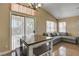 Open concept living area features vaulted ceilings, neutral paint and sliding doors to backyard at 6587 Lucky Boy Dr, Las Vegas, NV 89110