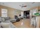 Spacious living room with comfortable seating, ceiling fan, and adjacent breakfast bar and kitchen area at 6587 Lucky Boy Dr, Las Vegas, NV 89110