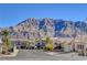 Picturesque street view with well-maintained homes and a backdrop of majestic mountains at 6587 Lucky Boy Dr, Las Vegas, NV 89110