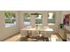 This dining room is bright, with lots of windows, modern furnishings, and hardwood floors at 6925 Unicorn St, Las Vegas, NV 89131