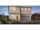 Charming two-story home featuring a gray stucco exterior, large windows, and an attached two-car garage at 7121 Serene Creek St, Las Vegas, NV 89131