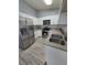 Updated kitchen featuring stainless steel appliances, white cabinetry, and granite countertops at 7324 Saybrook Point Dr, Las Vegas, NV 89128