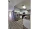 Kitchen with white cabinets, stainless steel appliances, and wood-look floors at 7324 Saybrook Point Dr, Las Vegas, NV 89128