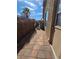 Sideyard with privacy lattice, tile paver walkway, and security gate at 7324 Saybrook Point Dr, Las Vegas, NV 89128